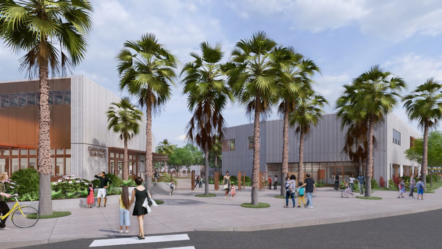 Ground-level view of the campus entry in the morning, with families walking in beneath tall palms past the cafetorium and classroom buildings.